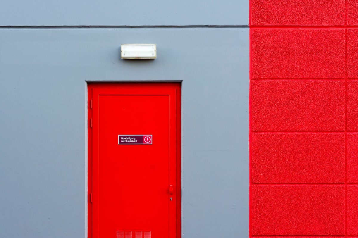 Panic Bars & Exit Devices — Red fire exit door fitted with a panic bar