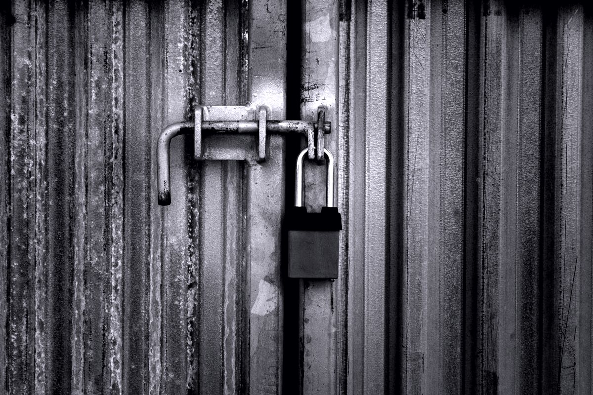 Window Security Bars — Heavy-duty padlock on a steel gate